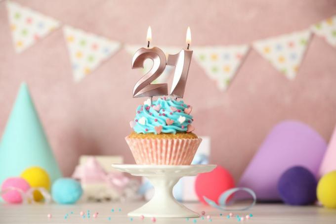 21. sünnipäeva kook numbriküünaldega valgel laual