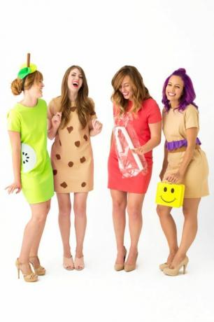 neli lühikeste kleitidega naeru, riietatud kui "lõunaprouad", kellest üks kannab kollast naerunäo lõunakasti